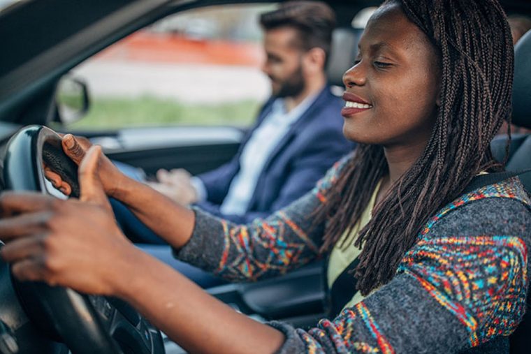 Woman driver man sitting in seat next to her