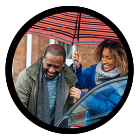 circular photo of woman holding umbrella over man