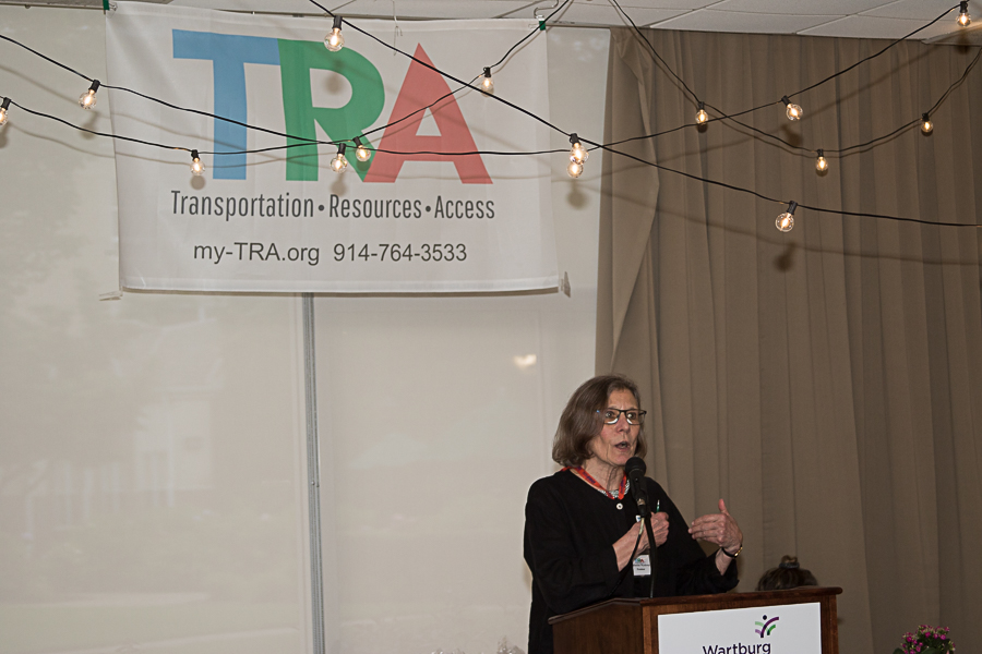 Kitty Wynkoop speaking with TRA banner in background