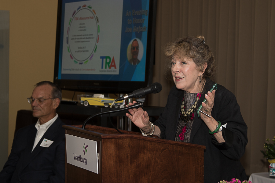 Linda Travis speaking at podium