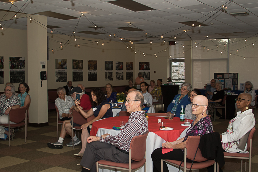 audience sitting at tables listening to presentation