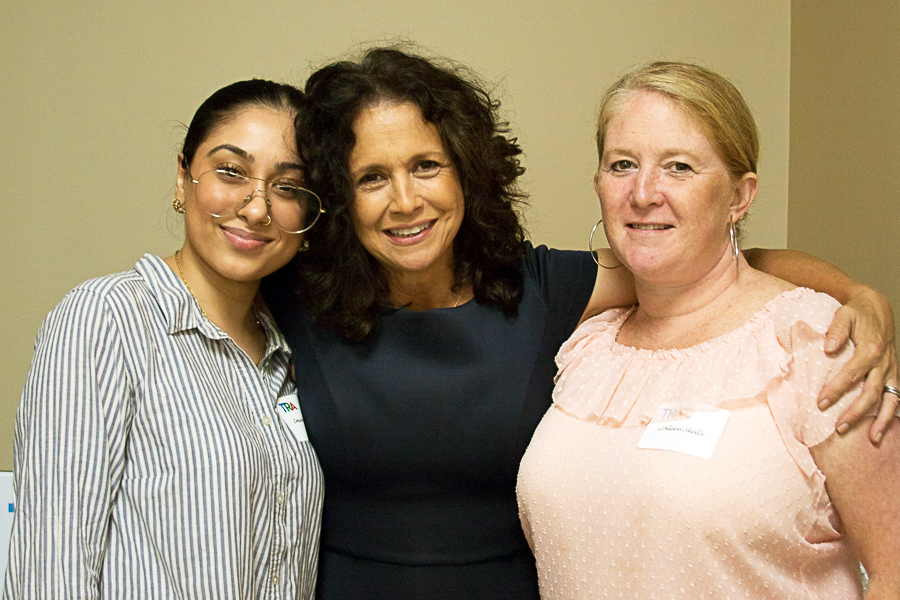 Three diverse women pose for photo at event