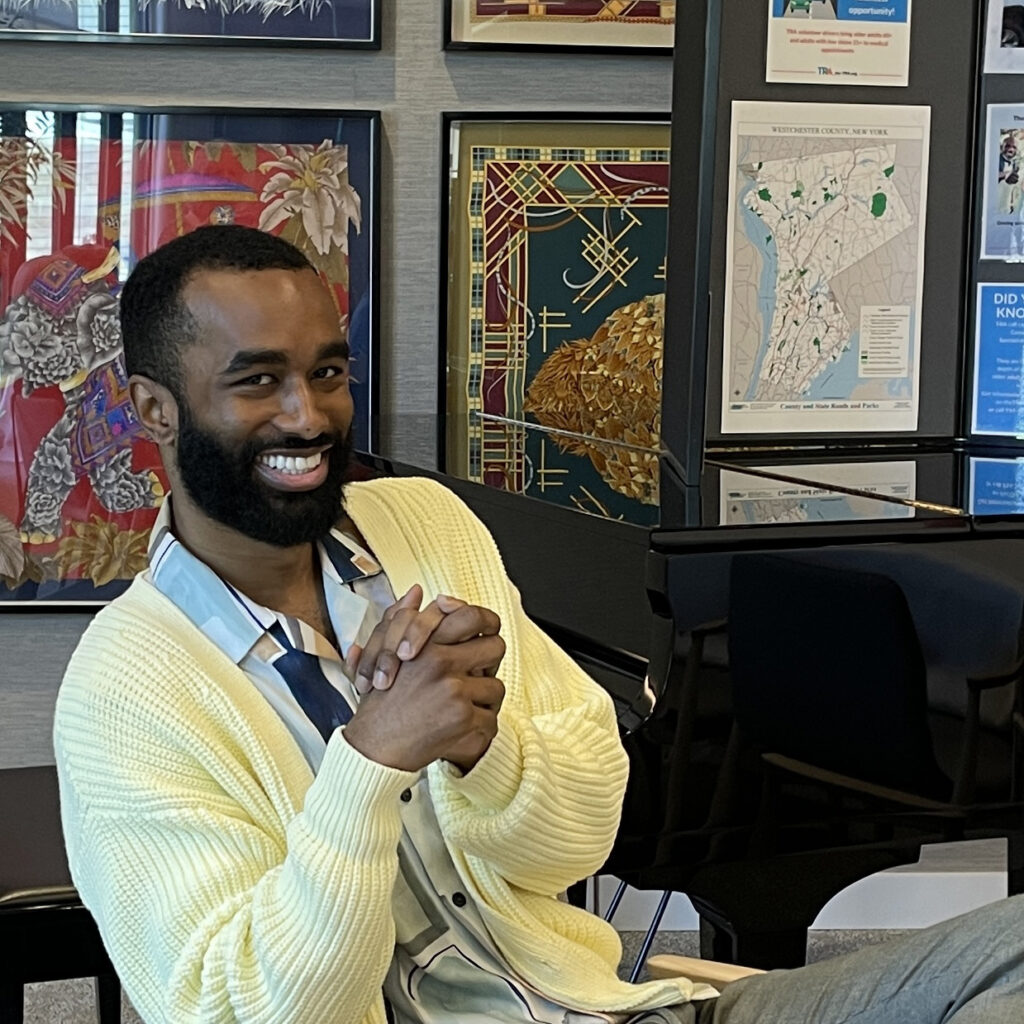 Board members sits comfortable and smiles towards camera