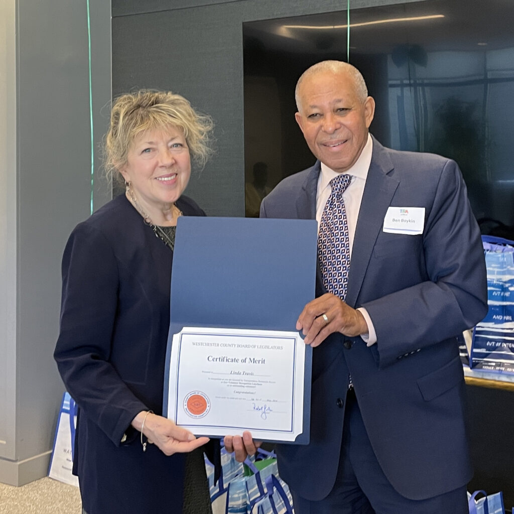 Legislator Boykin presents certificate of merit to smiling volunteer