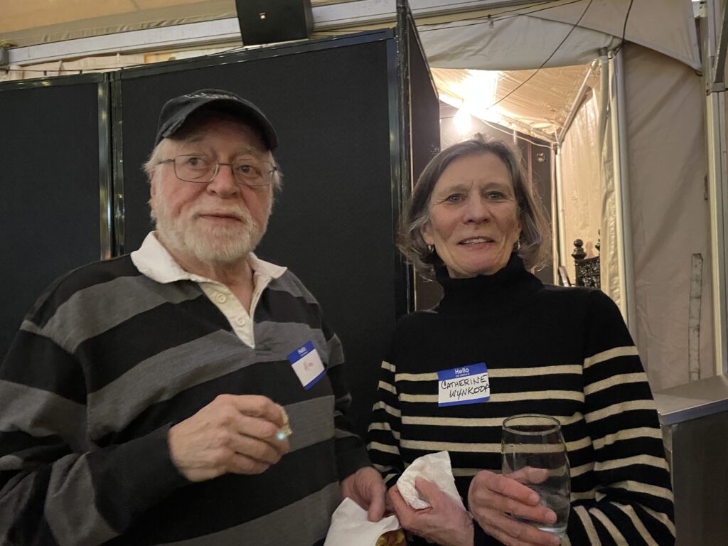 Standing and women, both have striped sweaters on