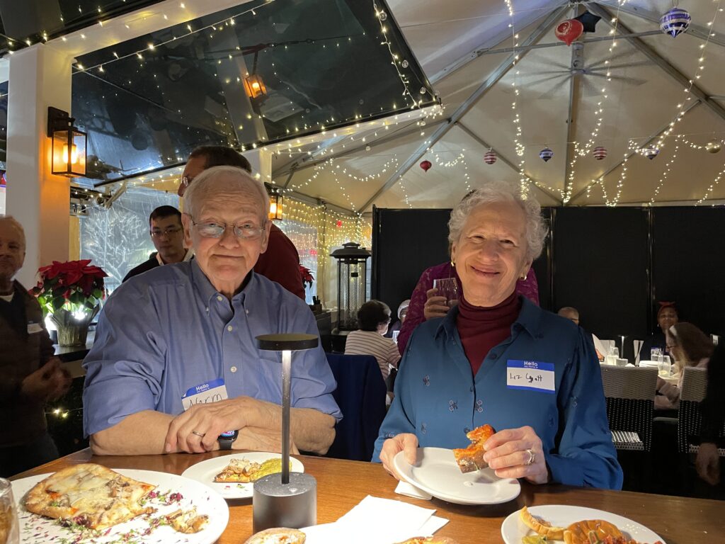 A man and a woman at high top table enjoying hors d'ordoeurvres