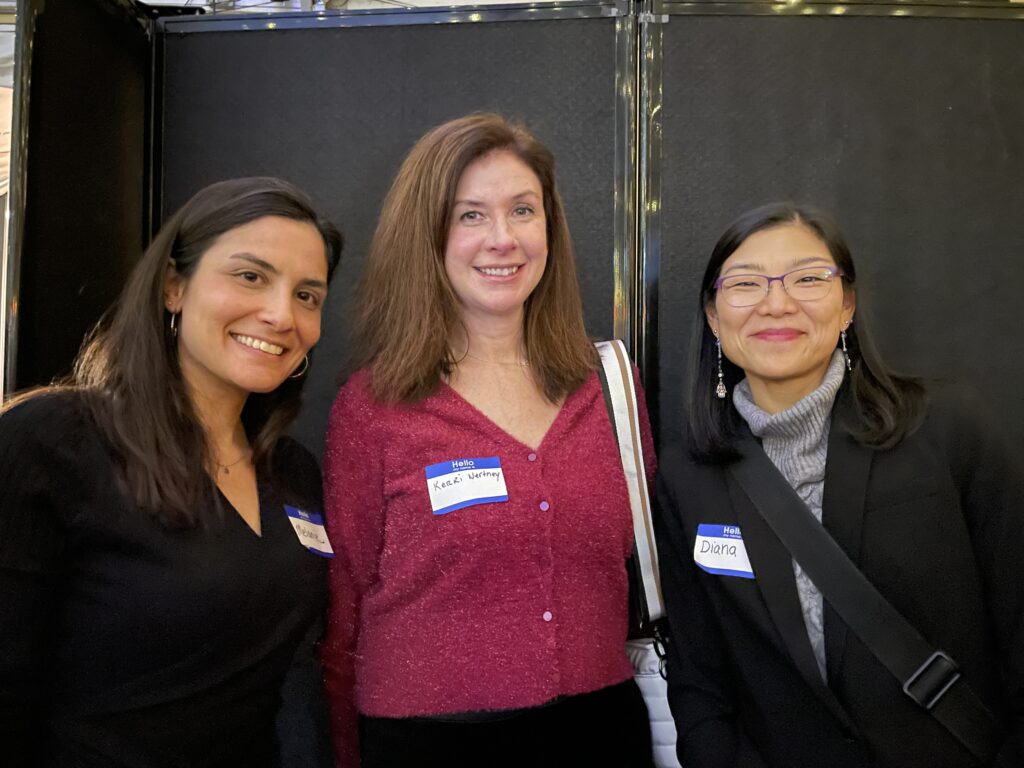 Three co-workers wear tags with their names