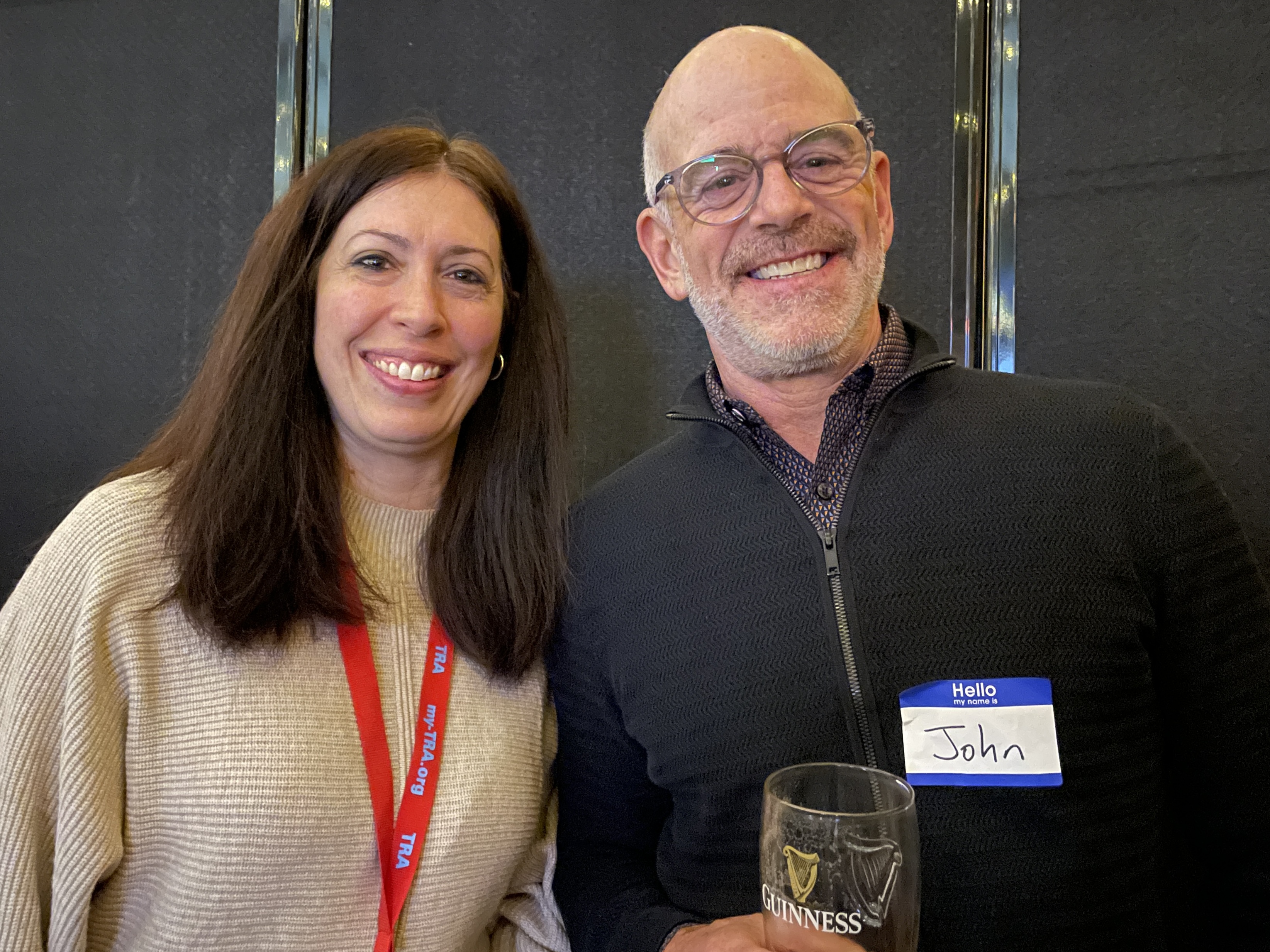 Smiling man and woman he holds a wine glass