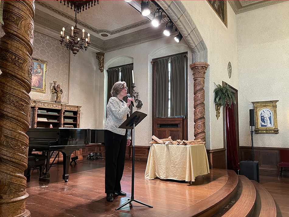 woan stands on elegant stage speaking to audience