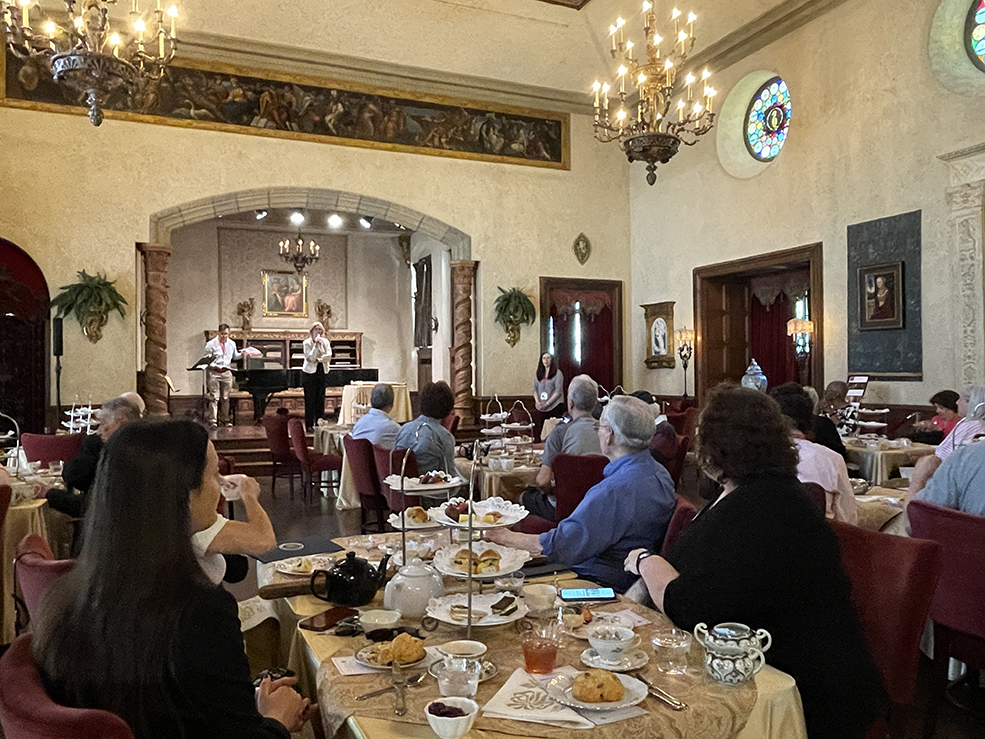 overview of tables and guests facing stage in elegant room