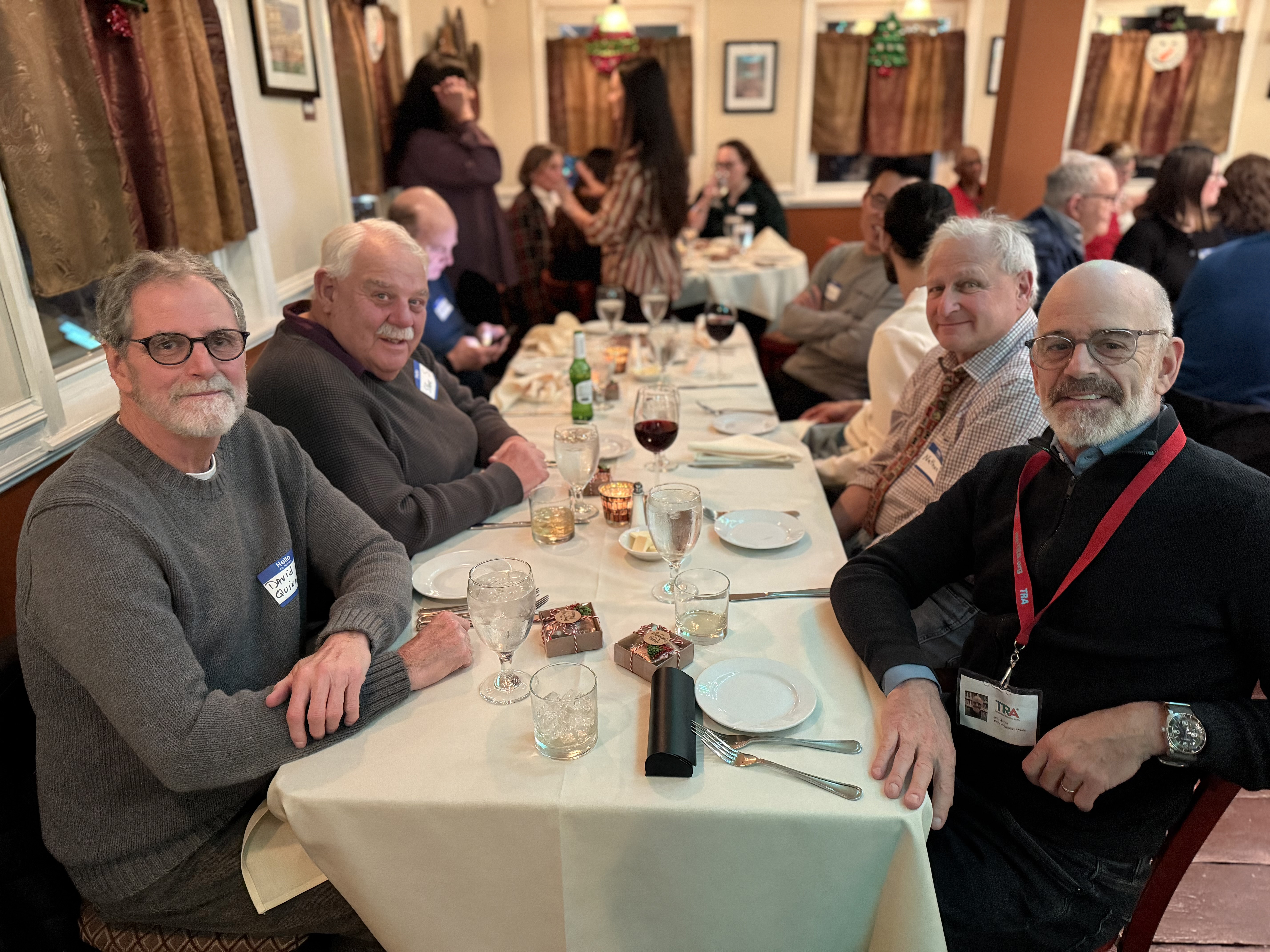 volunteers sit at festive table at volunteer winter luncheonmn