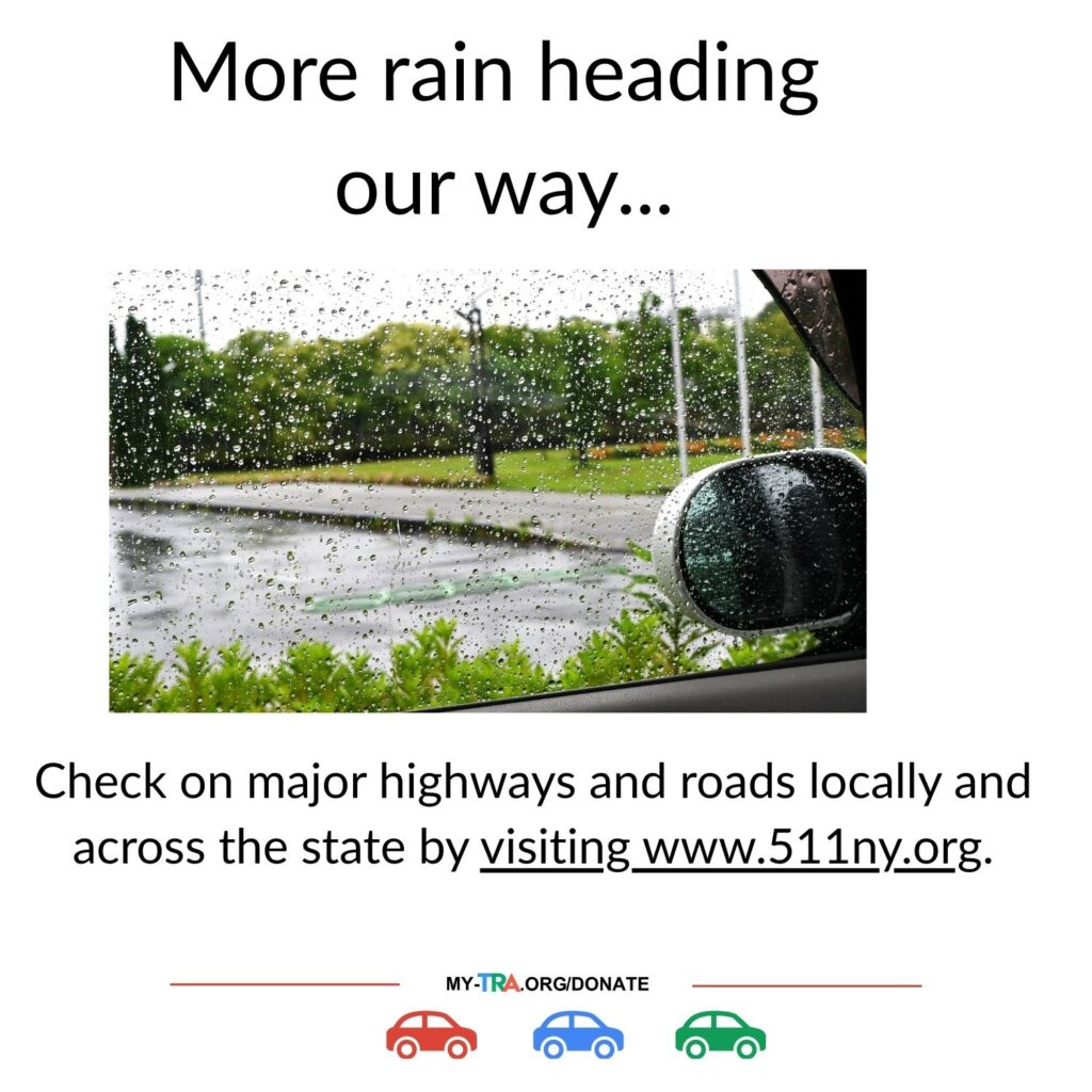 photograph from inside care through a rain splattered windshield and wet road 